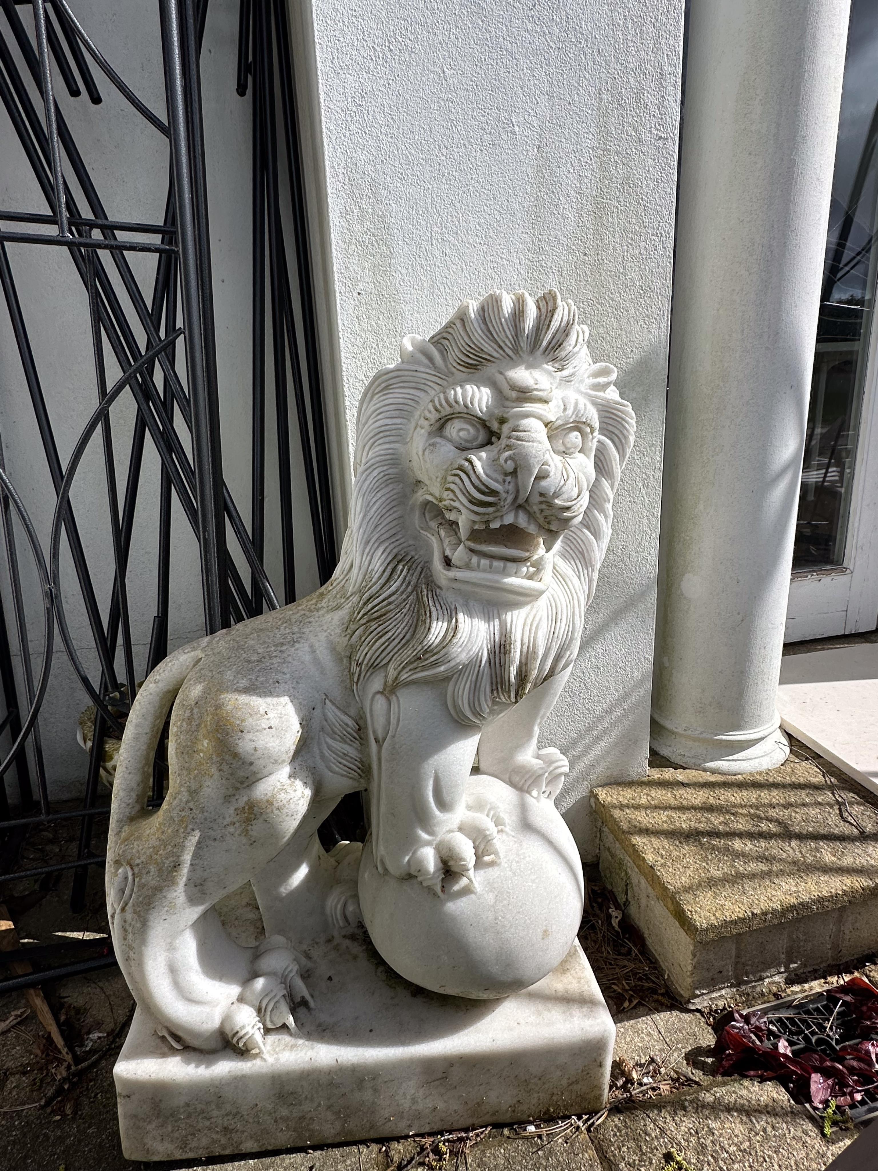 A pair of reconstituted white marble models of lions rampant